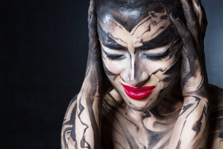 A painted woman with red lips.の写真素材