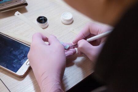 Drawing of the Easter pattern on the nails.の写真素材