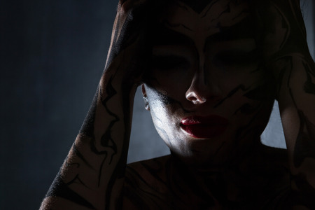 Silhouette of a woman in the dark.の写真素材