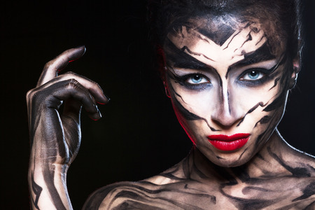 Woman in a gloomy image on a black background.の写真素材