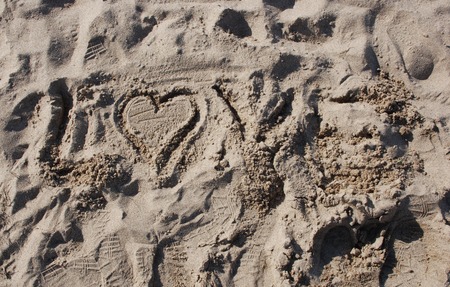 love drawn on sandの写真素材