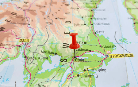 View of Orebro, is the seventh-largest city in Sweden, the seat of Orebro Municipality, and capital of Orebro County., on a geographical map of Europa, marked with red pushpinの写真素材