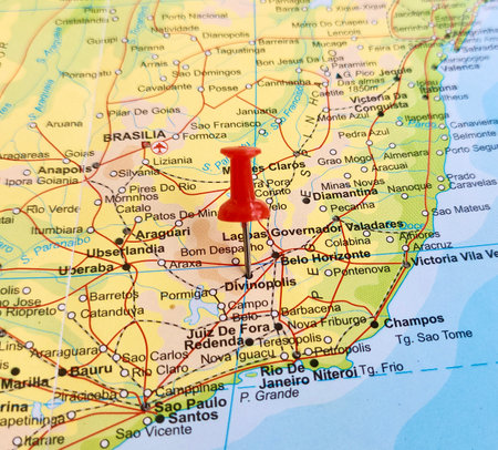 View of Divinopolis, is a municipality in the centre-west of Minas Gerais state, Brazil, on a geographical map of America, marked with red pushpinの写真素材