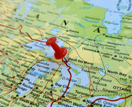 View of Sault Ste. Marie, is a city in the Upper Peninsula of the U.S. state of Michigan, United States, on a geographical map of America, marked with red pushpinの写真素材