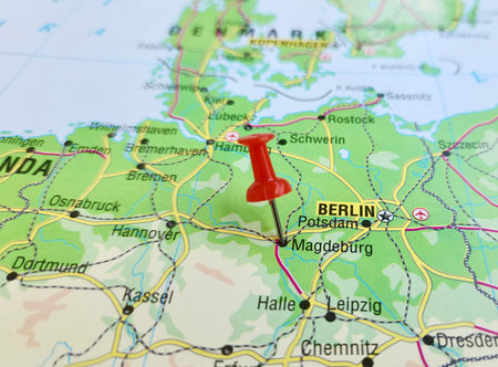 View of Magdeburg, Capital city of the German state of Saxony-Anhalt, on a geographical map of Europe, marked with red pushpinの写真素材
