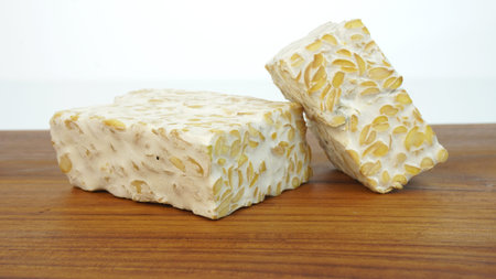 Tempeh or soybean cake, a source of vegetable protein made from boiled soybeans and given yeast...