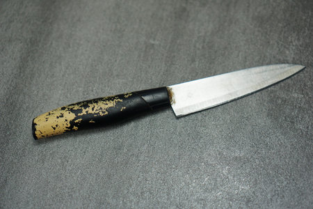 old kitchen knife lying on gray background