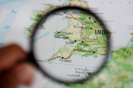 view of Cardiff, Capital city of Wales, United Kingdom on a geographical map of Europe, seen using a magnifying glassの写真素材