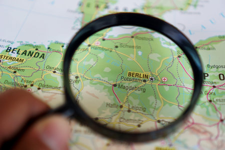 view of Berlin, Germany on a geographic map of Europe, seen using a magnifying glass