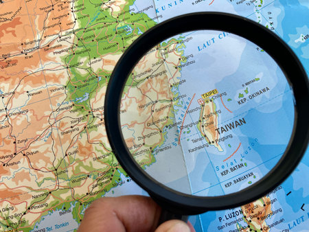 view of Taiwan ,Country in East Asia on a geographical map of Asia, seen using a magnifying glassの写真素材