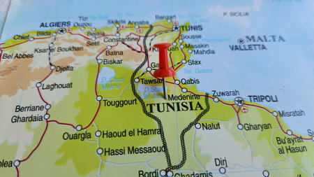 View of Tunisia, officially the Republic of Tunisia, is a country in the Maghreb region of North Africa, on a geographical map of Africa, marked with red pushpinの写真素材