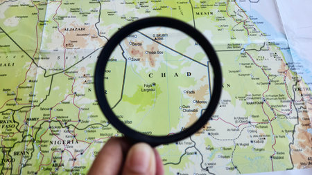 View of Chad, on a geographic map of Africa, seen using a magnifying glassの写真素材