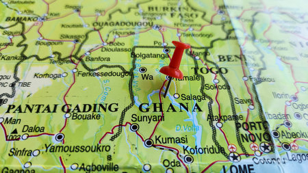View of Ghana, officially the Republic of Ghana, is a country in West Africa, on a geographical map of Africa, marked with red push pinの写真素材