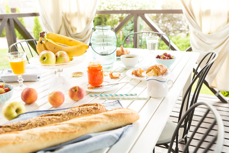 Summer outdoor continental breakfast on the garden terrace. Countryside weekend or rural holiday scenery.の写真素材