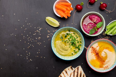 Colorful vegetarian snacks (appetizers) table. Various dips with pita bread. Flat lay composition...