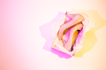 High heels in a box - women's footwear (shoes). Colorful (multicolor tonal transitions) background. Layout with free copy (text) space.の写真素材