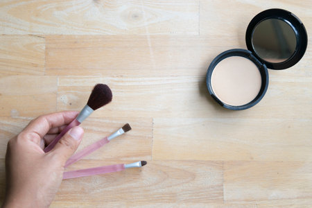 hand brush and power on wood backgroundの写真素材