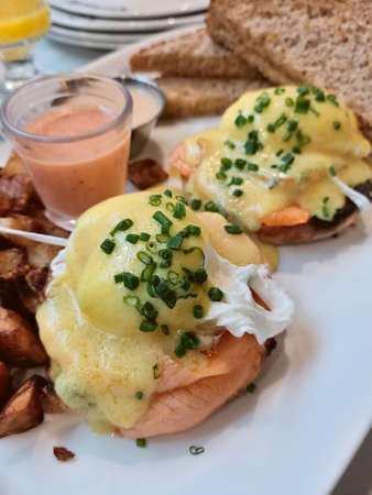 Egg Benedict with salmon, spinach and hollandaise sauceの写真素材