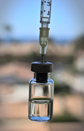 Vaccine bottle and syringe with injection fluid and aluminum