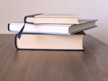 Stack of books on a table with light colored background.Education learning and reading conceptの写真素材