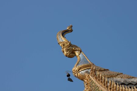 thai temple roof and nice blue skyの写真素材