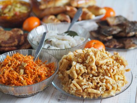 Cake anthill or chuck-chuck with honey filling, on the background of a table with another meal. The rustic table.の写真素材