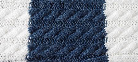 Knitted fabric texture. Blue and white color. Knitting on the knitting needles. Combined openwork...