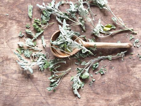 Dry medicinal herb lemon balm, mint. Wood background. Herbal tea for health.の写真素材