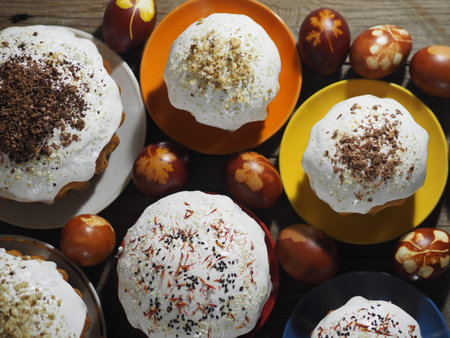Cooking Easter cakes at home. Easter baking with painted eggs on a wooden ancient background.