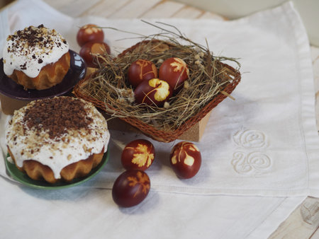 Easter. Traditional Easter pastries, painted onion peel eggs on a natural tablecloth. Night dark...