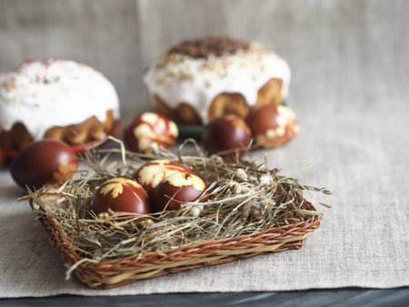 Easter baking with Easter eggs dyed with onion husks with imprints of fresh leaves, on a fabric...