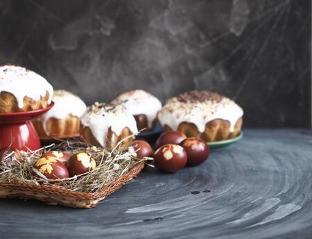 Easter baking with Easter eggs painted onion husks with prints of fresh leaves, on a wooden background.の写真素材