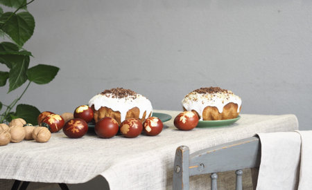 Easter baking with Easter eggs dyed with onion husks with imprints of fresh leaves, on a fabric...