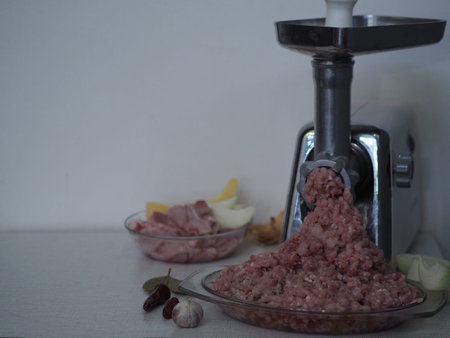 Raw rabbit meat, inced meat twisted through a meat grinder on a wooden ancient table, sliced meat...
