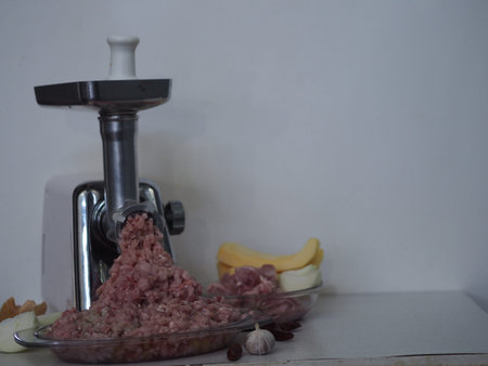 Raw rabbit meat, inced meat twisted through a meat grinder on a wooden ancient table, sliced meat...