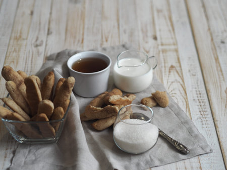 Homemade shortbread biscuits with cinnamon and nuts on a white wooden table. Home kitchen. We bake...