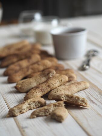 Homemade shortbread biscuits with cinnamon and nuts on a white wooden table. Home kitchen. We bake cookies.の写真素材