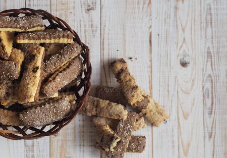Homemade shortbread puff pastry chocolate chip cookies on a wooden white table. View from above.の写真素材