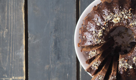 Festive homemade cakes. Round chocolate muffin, large muffin or cake with chocolate icing on a...