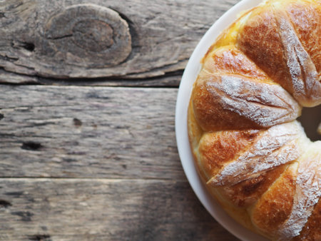 Festive Easter, Christmas or everyday bread rolls on a wooden rustic ancient table.Homemade cake.The...