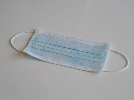 Medical face masks on a white wooden background. Coronavirus protection mask, empty space.The view...