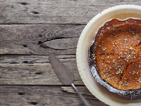 Pumpkin Background. Baked pumpkin sprinkled with ground walnuts on a wooden ancient background with ingredients. Top view. Place for text.の写真素材