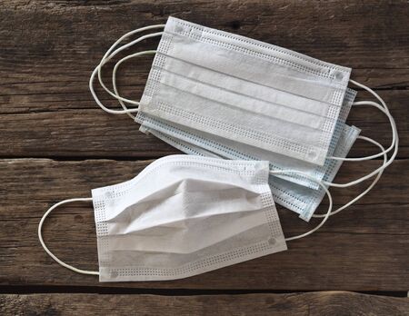 Medical respiratory protective face masks against influenza virus on on wooden ancient natural...