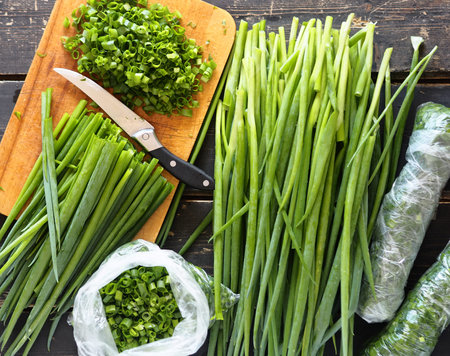Background with green onions.Harvesting,storage, and freezing of vegetables and fruits. The process...
