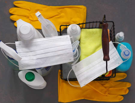 The concept of general cleaning and disinfection of the house with the use of detergents and disinfectants. The use of protective medical masks and rubber gloves to protect health.の写真素材