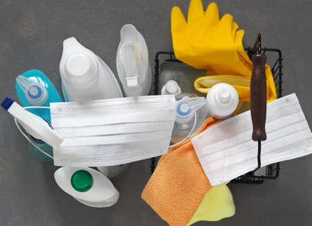 Plastic bottles with detergents and disinfectants on a gray background for cleaning and disinfecting at home. View from above.の写真素材