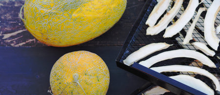 Autumn fruit food agricultural background. A melon is laid out against a dark background for drying...