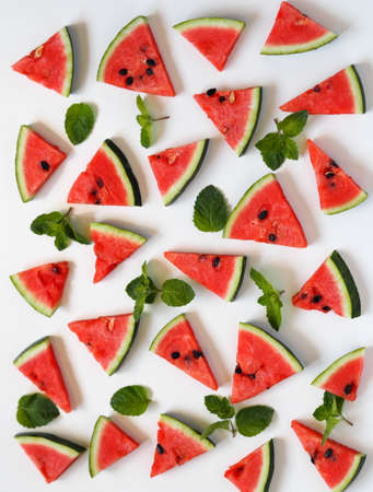Food background with watermelon slices and mint leaves. Healthy natural food rich in vitamins. Watermelon is a popular organic farming product.の写真素材