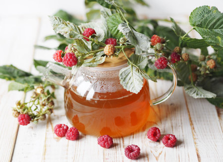 Autumn late raspberries.Useful properties of medicinal tea with raspberries. Branch with raspberries...