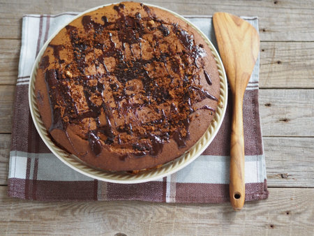Festive homemade cakes. Round chocolate muffin, large cupcake or chocolate cake on a wooden ancient background. Place for text. View from above.の写真素材